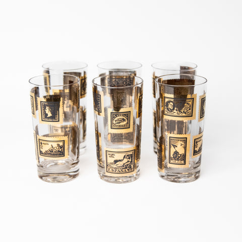 SET OF SIX VINTAGE HIGHBALL GLASSES FEATURING GOLD STAMP MOTIFS FROM AROUND THE GLOBE